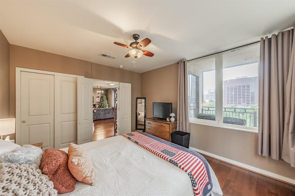 1200 Main Street, Unit 306 Dallas, TX 75202 - Photo 23 of 35 a bedroom with a bed dresser and a large window