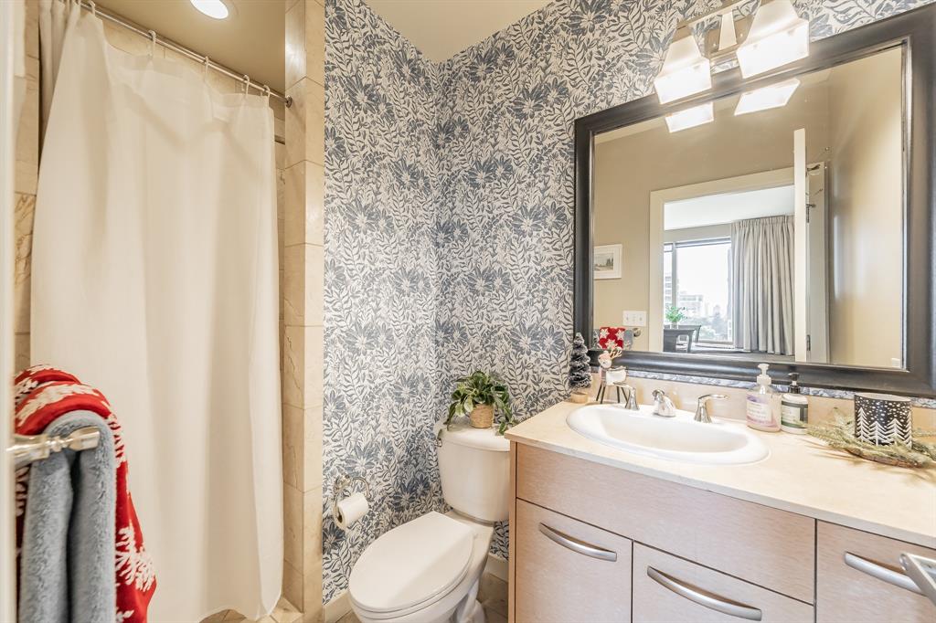 1200 Main Street, Unit 306 Dallas, TX 75202 - Photo 27 of 35 a bathroom with a sink vanity mirror and toilet
