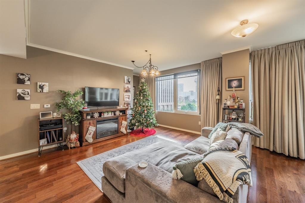 1200 Main Street, Unit 306 Dallas, TX 75202 - Photo 4 of 35 a bed room with a bed window and a television