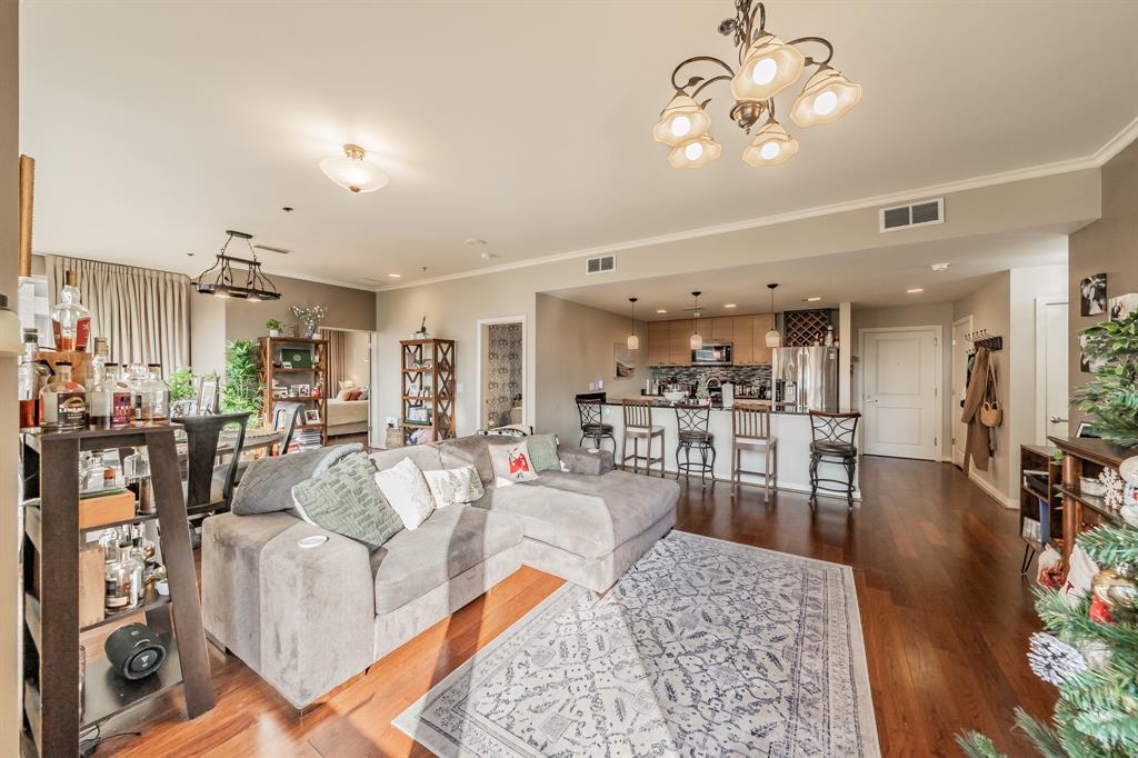 1200 Main Street, Unit 306 Dallas, TX 75202 - Photo 5 of 35 a living room with lots of furniture and view of kitchen