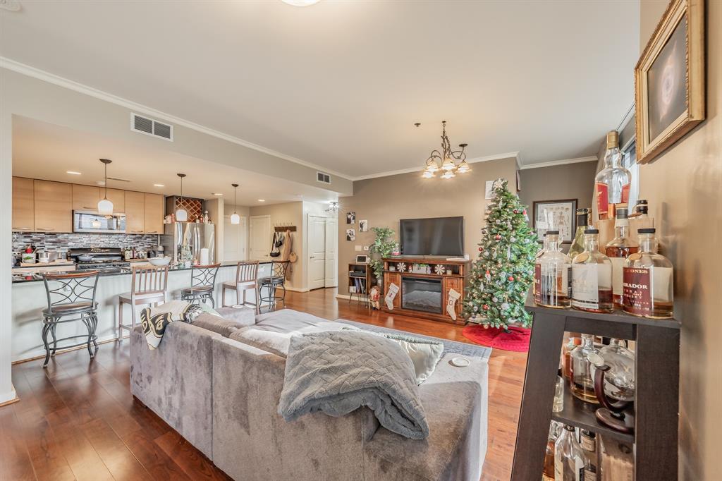 1200 Main Street, Unit 306 Dallas, TX 75202 - Photo 6 of 35 a living room with furniture and a view of kitchen