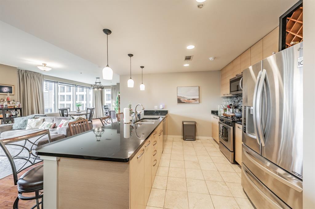 1200 Main Street, Unit 306 Dallas, TX 75202 - Photo 35 of 35 a large kitchen with a large counter top appliances and cabinets