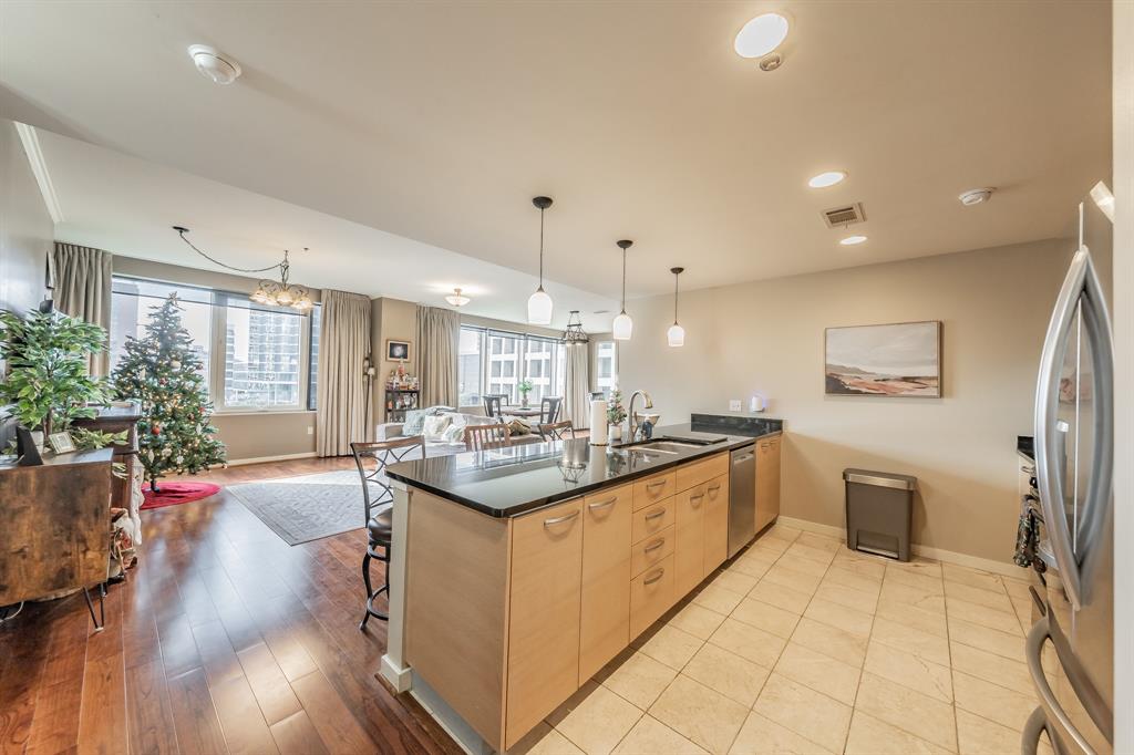1200 Main Street, Unit 306 Dallas, TX 75202 - Photo 9 of 35 a kitchen with stainless steel appliances granite countertop a sink and cabinets