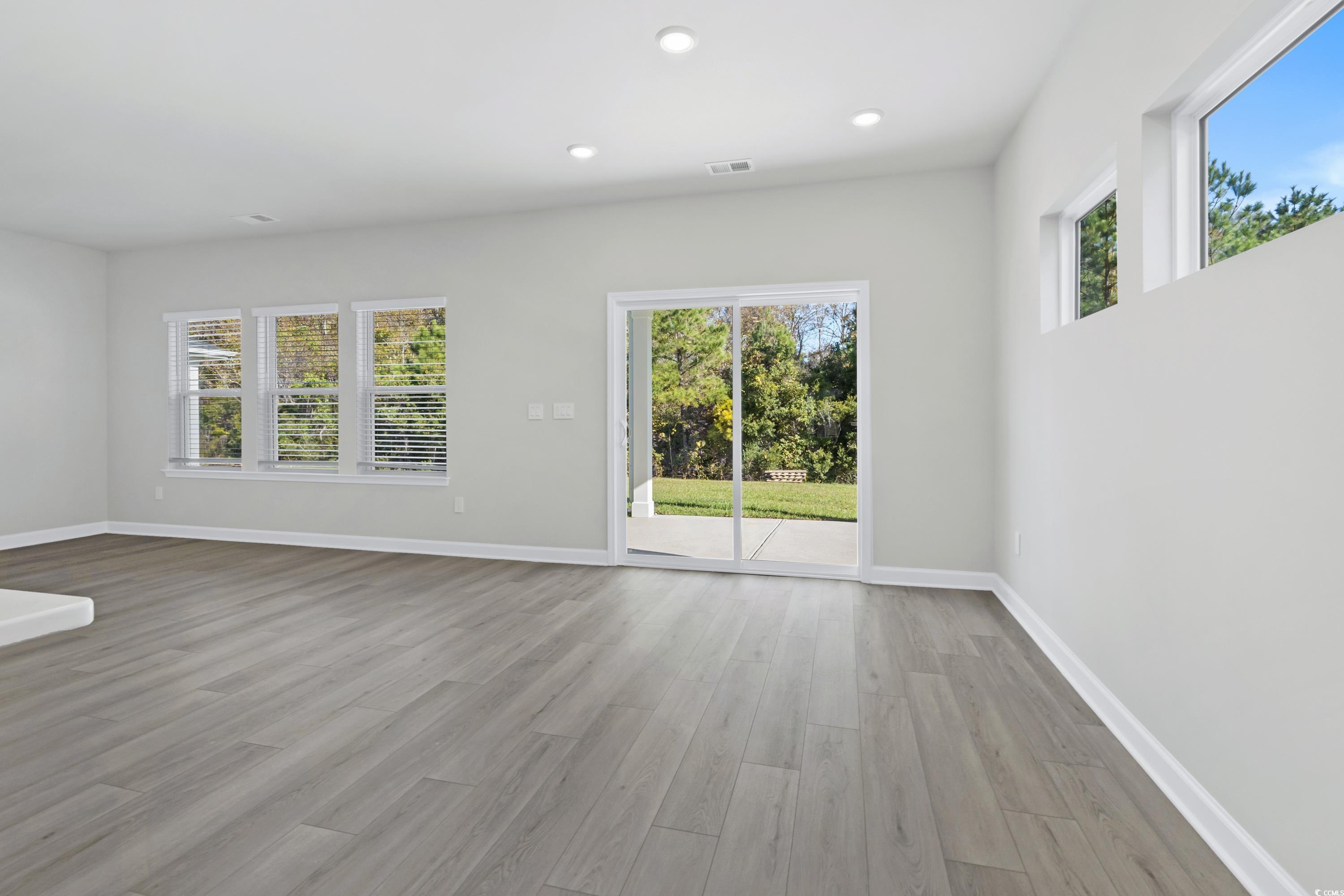 2409 Grand Mdw Drive Longs, SC 29568 - Photo 11 of 40 Unfurnished living room with light wood-type floor