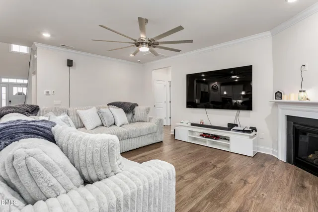 a kitchen with stainless steel appliances kitchen island granite countertop a table chairs and a refrigerator