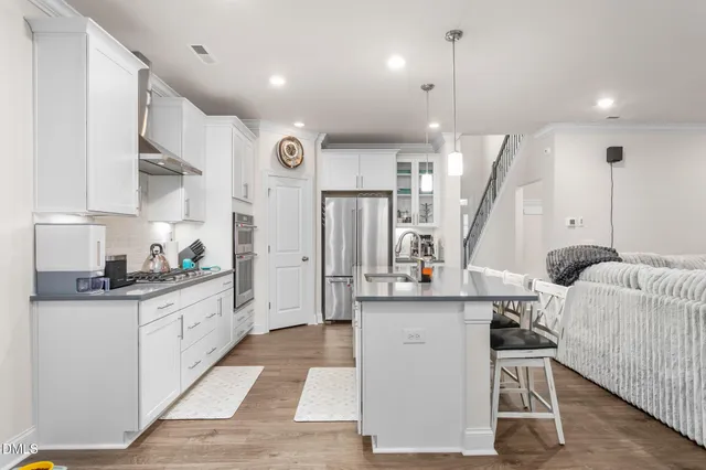 a kitchen with a sink refrigerator and microwave