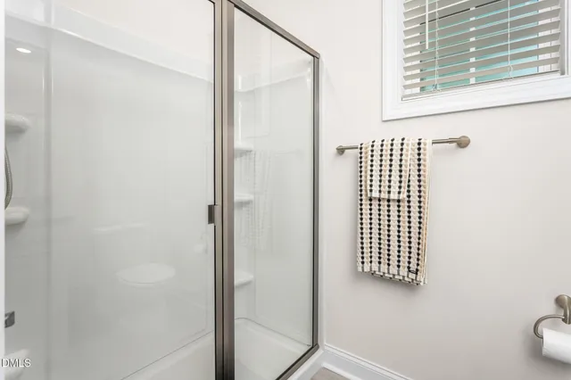 a view of a hallway with a livingroom and furniture