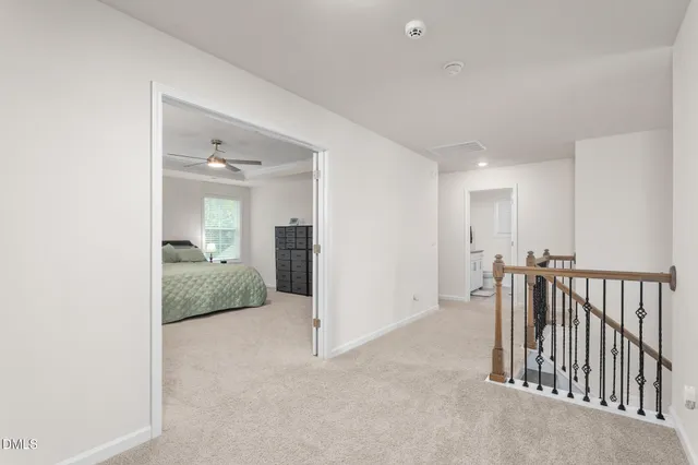 a bedroom with a bed dresser and a window