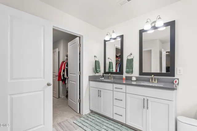 a bathroom with a tub a sink and mirror