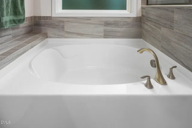 a view of walk in closet with clothes