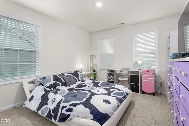 a bathroom with a granite countertop toilet sink and mirror