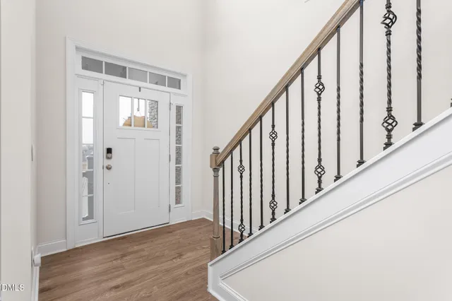 a view of entryway and hall with wooden floor