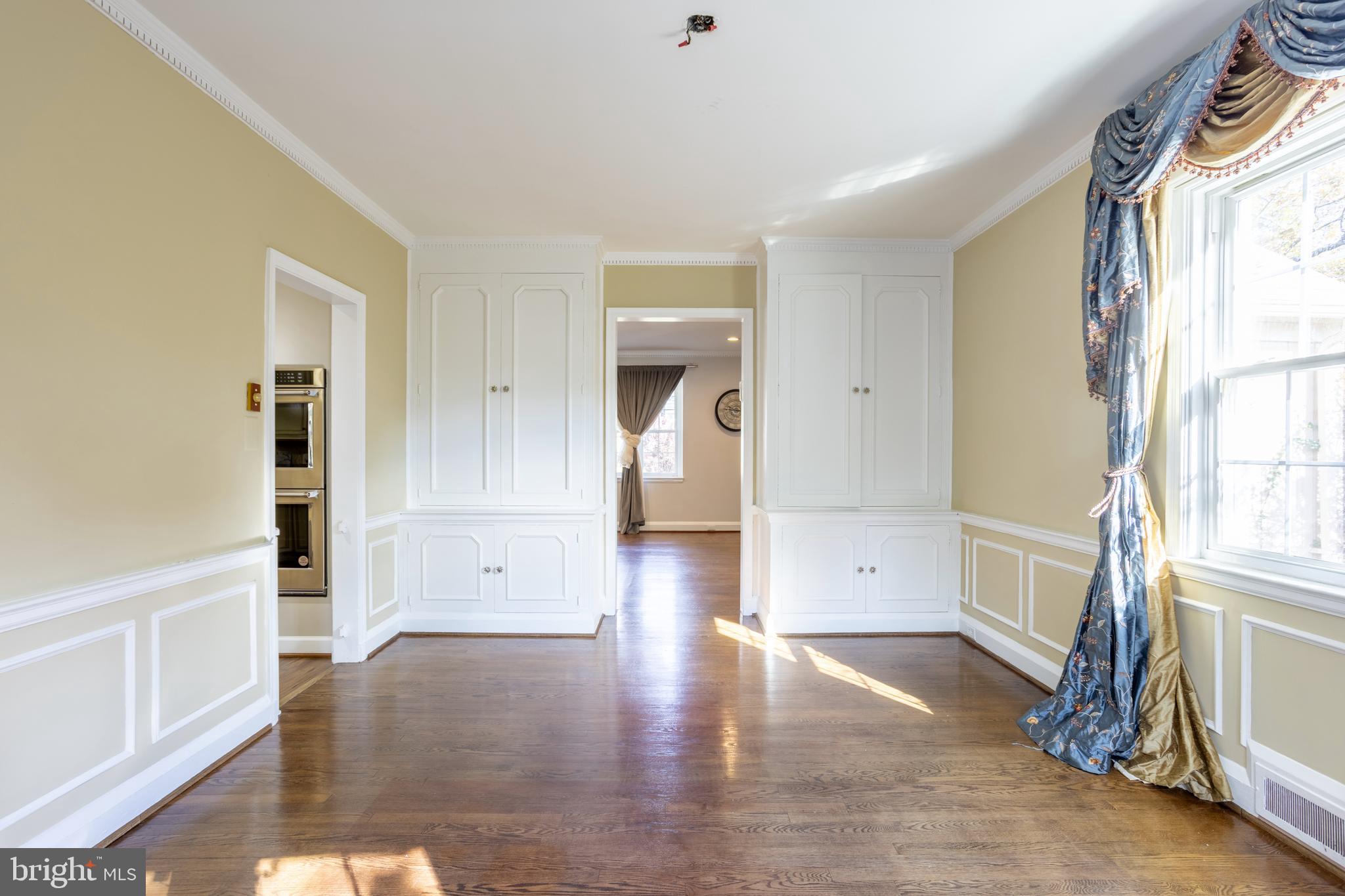 3306 Labyrinth Road Baltimore, MD 21215 - Photo 11 of 66 a view of an empty room with window and wooden floor
