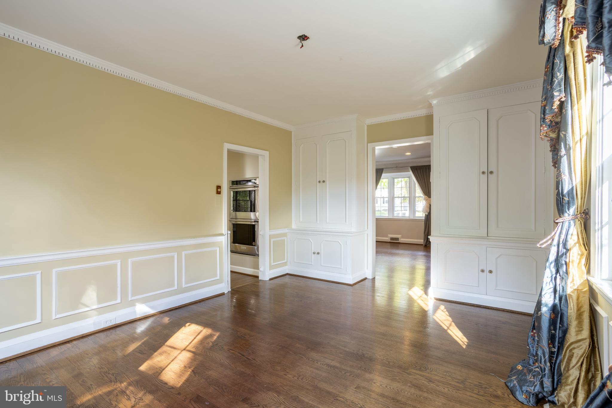 3306 Labyrinth Road Baltimore, MD 21215 - Photo 12 of 66 wooden floor in an empty room with a window