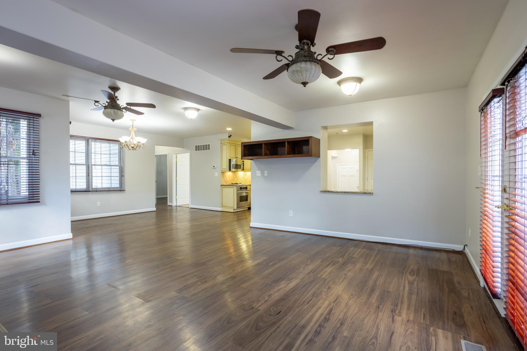 3306 Labyrinth Road Baltimore, MD 21215 - Photo 22 of 66 a view of an empty room with a window and wooden floor