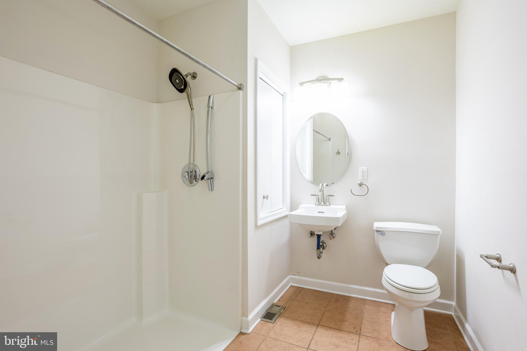 3306 Labyrinth Road Baltimore, MD 21215 - Photo 25 of 66 a bathroom with a toilet a sink and shower