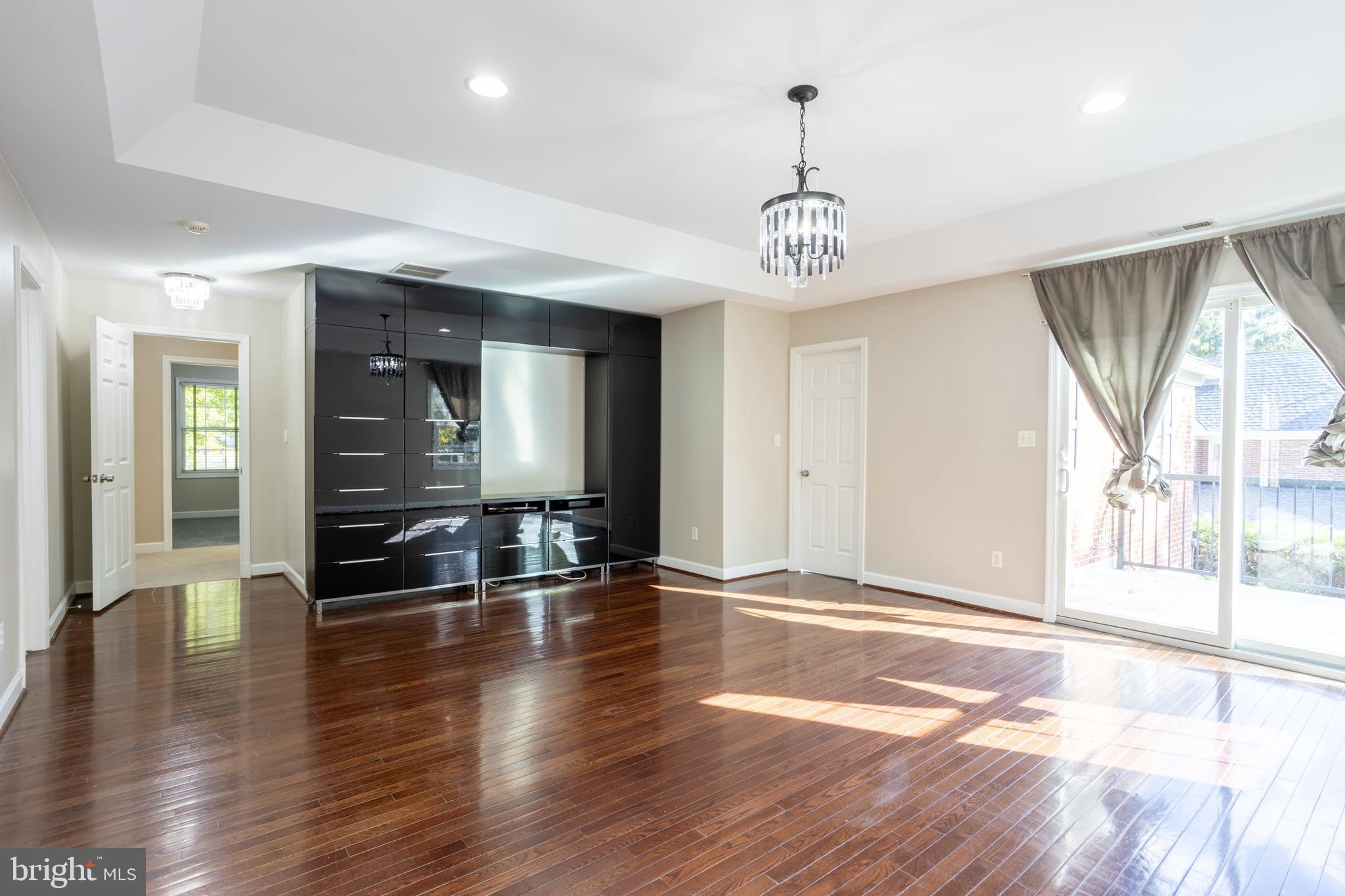 3306 Labyrinth Road Baltimore, MD 21215 - Photo 32 of 66 an empty room with wooden floor and windows