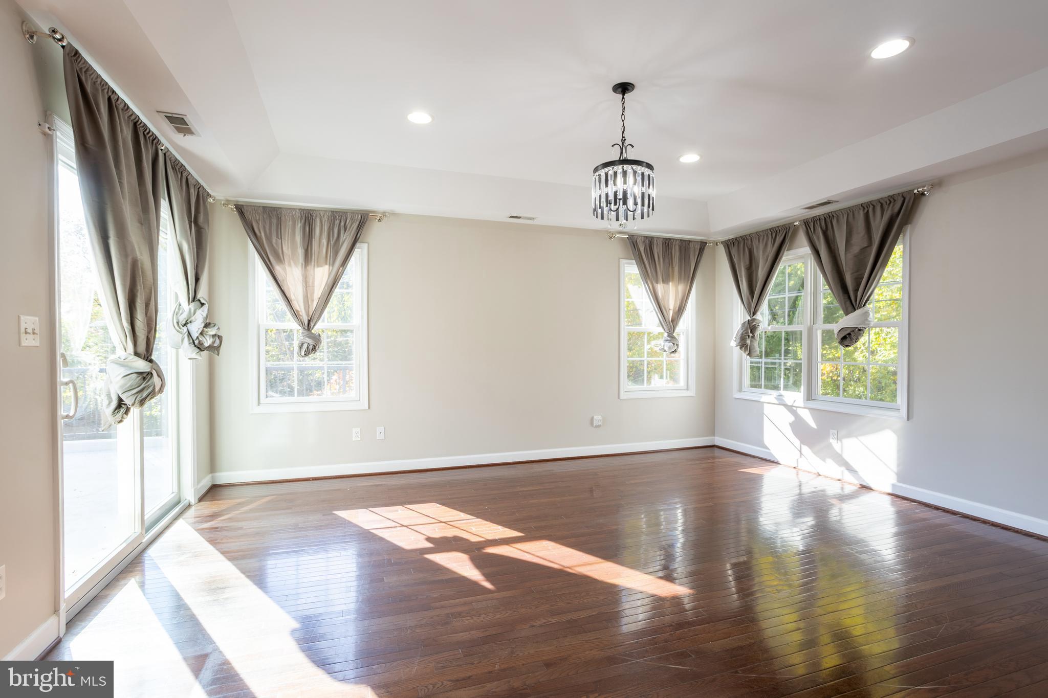 3306 Labyrinth Road Baltimore, MD 21215 - Photo 33 of 66 a view of an empty room with wooden floor and a window