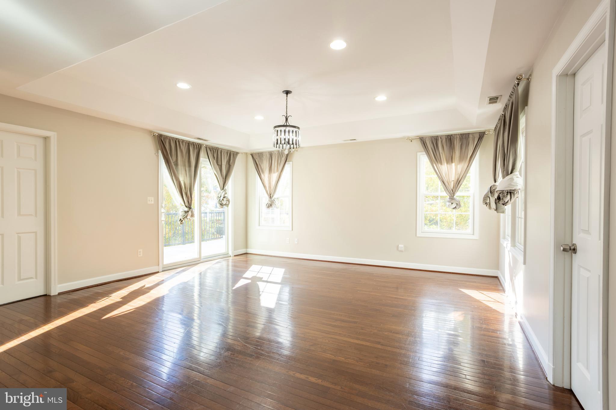 3306 Labyrinth Road Baltimore, MD 21215 - Photo 34 of 66 a view of an empty room with wooden floor and a window