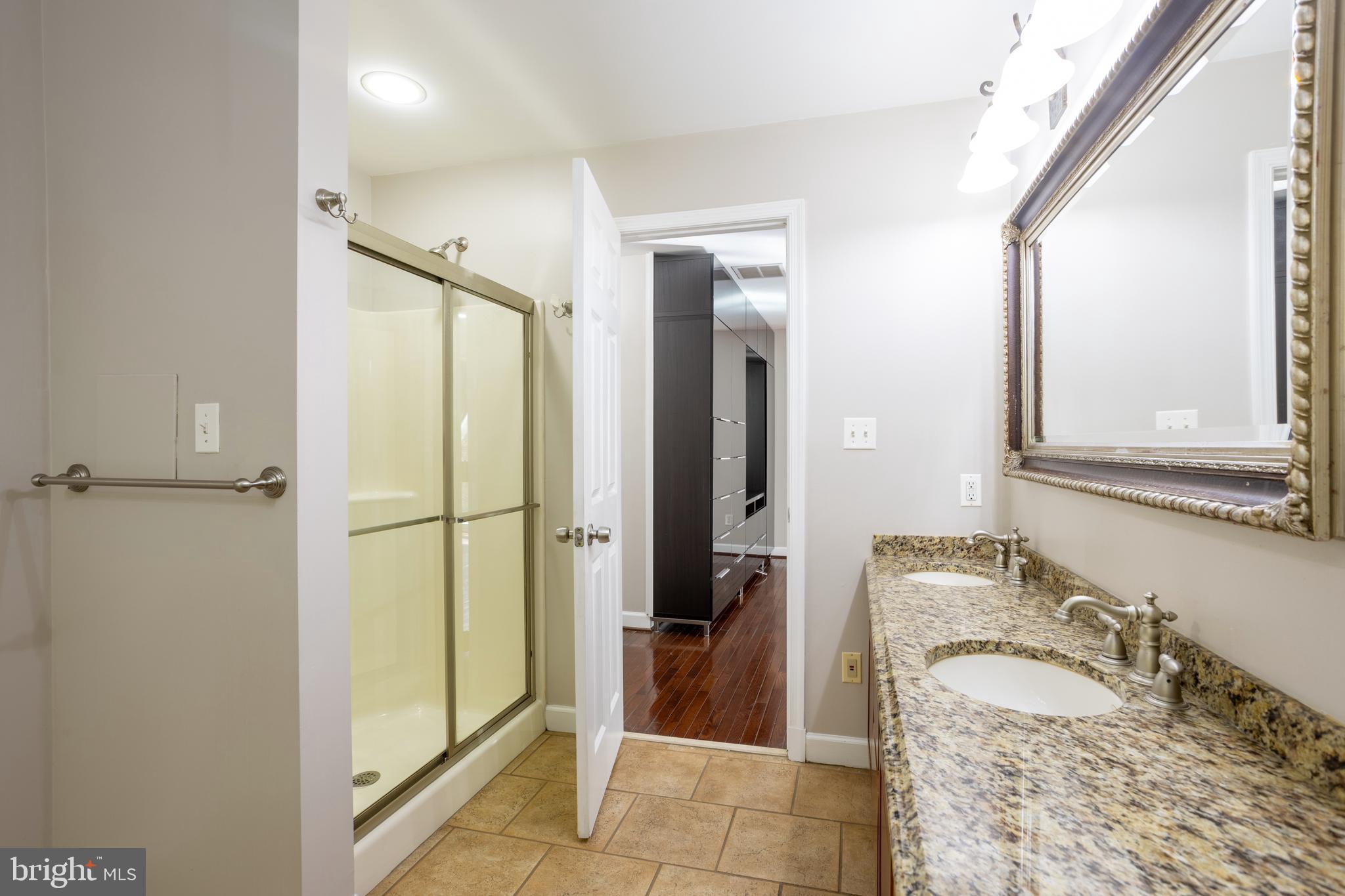 3306 Labyrinth Road Baltimore, MD 21215 - Photo 36 of 66 a bathroom with a granite countertop sink and a mirror