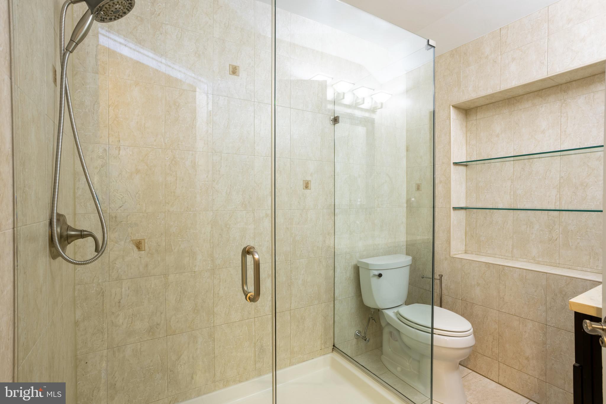 3306 Labyrinth Road Baltimore, MD 21215 - Photo 46 of 66 a bathroom with a toilet and a shower