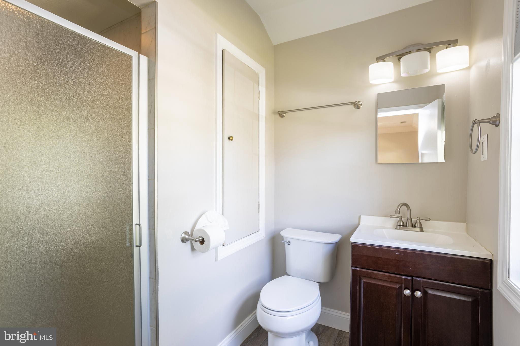 3306 Labyrinth Road Baltimore, MD 21215 - Photo 49 of 66 a bathroom with a sink toilet and vanity