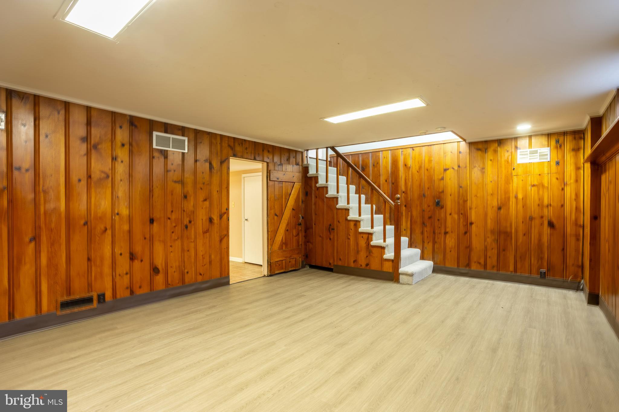 3306 Labyrinth Road Baltimore, MD 21215 - Photo 53 of 66 a view of an empty room with wooden walls