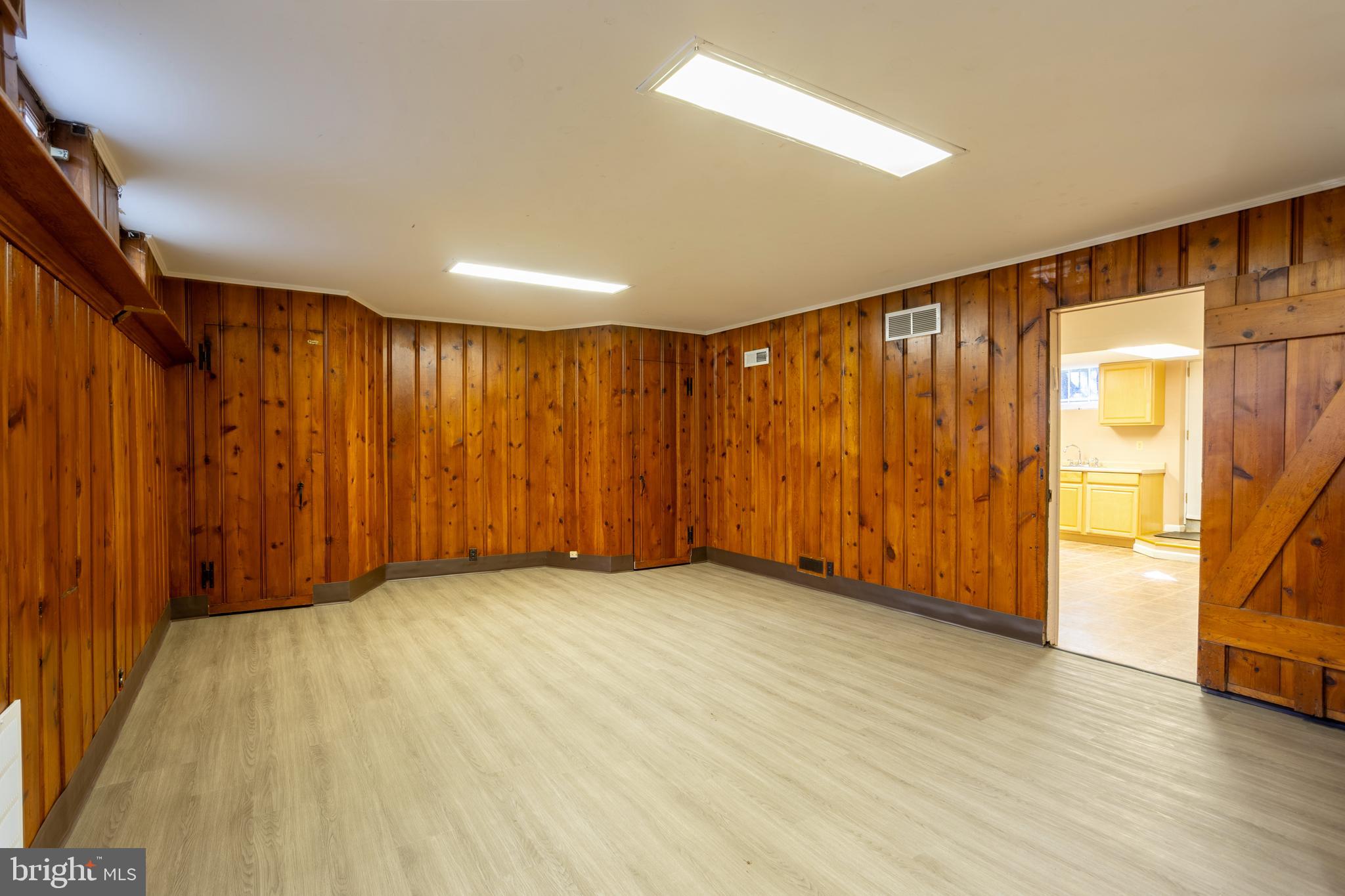 3306 Labyrinth Road Baltimore, MD 21215 - Photo 55 of 66 a view of an empty room with wooden floor and a window
