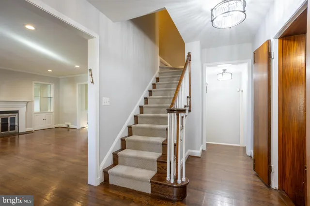 an empty room with wooden floor and a fireplace