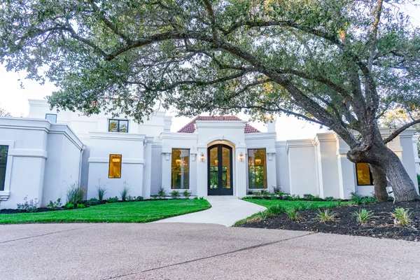 a front view of a house with garden
