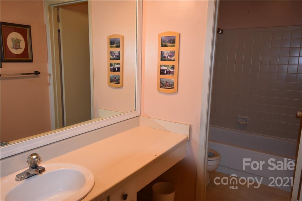4906 Sardis Road, Unit E Charlotte, NC 28270 - Photo 14 of 24 a bathroom with a sink and a mirror