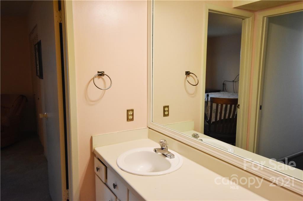 4906 Sardis Road, Unit E Charlotte, NC 28270 - Photo 16 of 24 a bathroom with a sink and a mirror