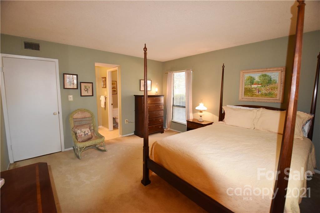 4906 Sardis Road, Unit E Charlotte, NC 28270 - Photo 18 of 24 a bedroom with a bed dresser and a window