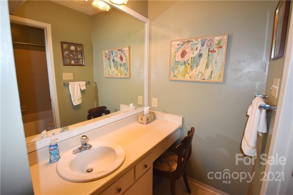 4906 Sardis Road, Unit E Charlotte, NC 28270 - Photo 21 of 24 a bathroom with a sink mirror and vanity