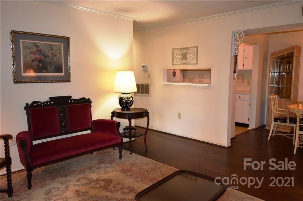 4906 Sardis Road, Unit E Charlotte, NC 28270 - Photo 4 of 24 a living room with furniture a rug and a lamp