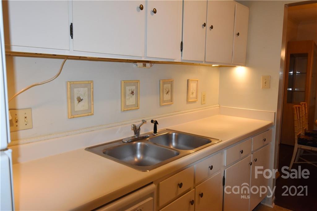4906 Sardis Road, Unit E Charlotte, NC 28270 - Photo 8 of 24 a kitchen with stainless steel appliances granite countertop a sink and a white cabinets