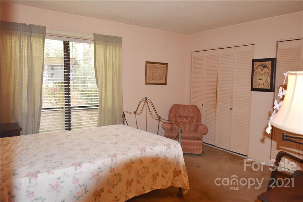 4906 Sardis Road, Unit E Charlotte, NC 28270 - Photo 10 of 24 a bedroom with a bed and a table in it