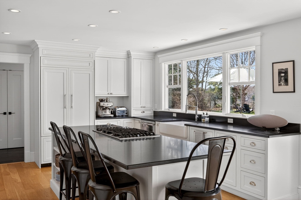 70 Judges Way Chatham, MA 02633 - Photo 9 of 41 a kitchen with a table chairs stove and cabinets