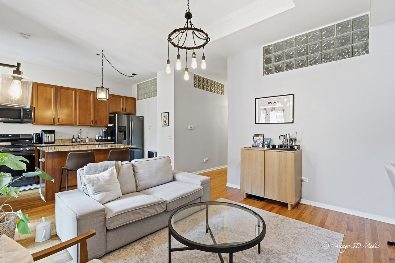 208 West Washington Street, Unit 1007 Chicago, IL 60606 - Photo 8 of 18 a living room with furniture kitchen view and a chandelier