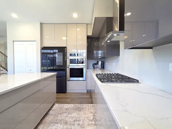 a kitchen with stainless steel appliances granite countertop a stove a sink and a refrigerator