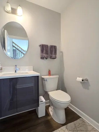 a white toilet sitting next to a bathroom sink