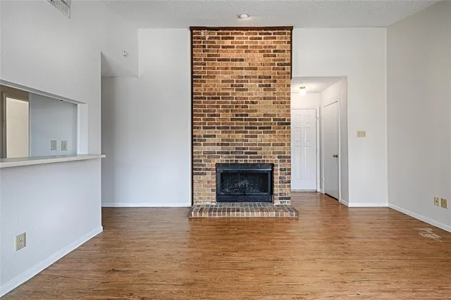 a view of fireplace and wooden floor