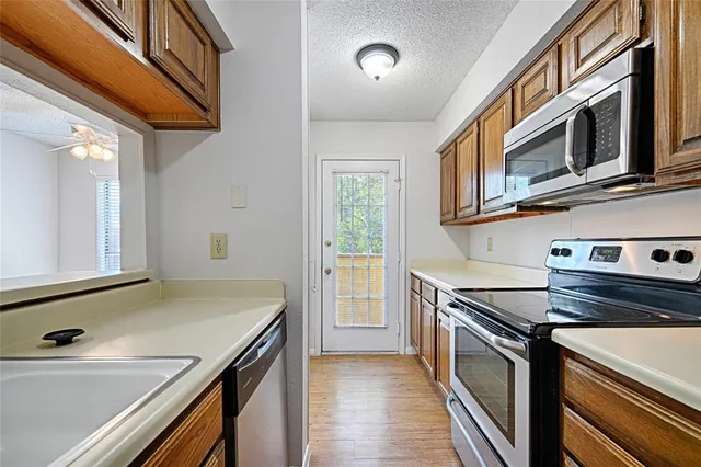 a kitchen with stainless steel appliances a stove and a sink