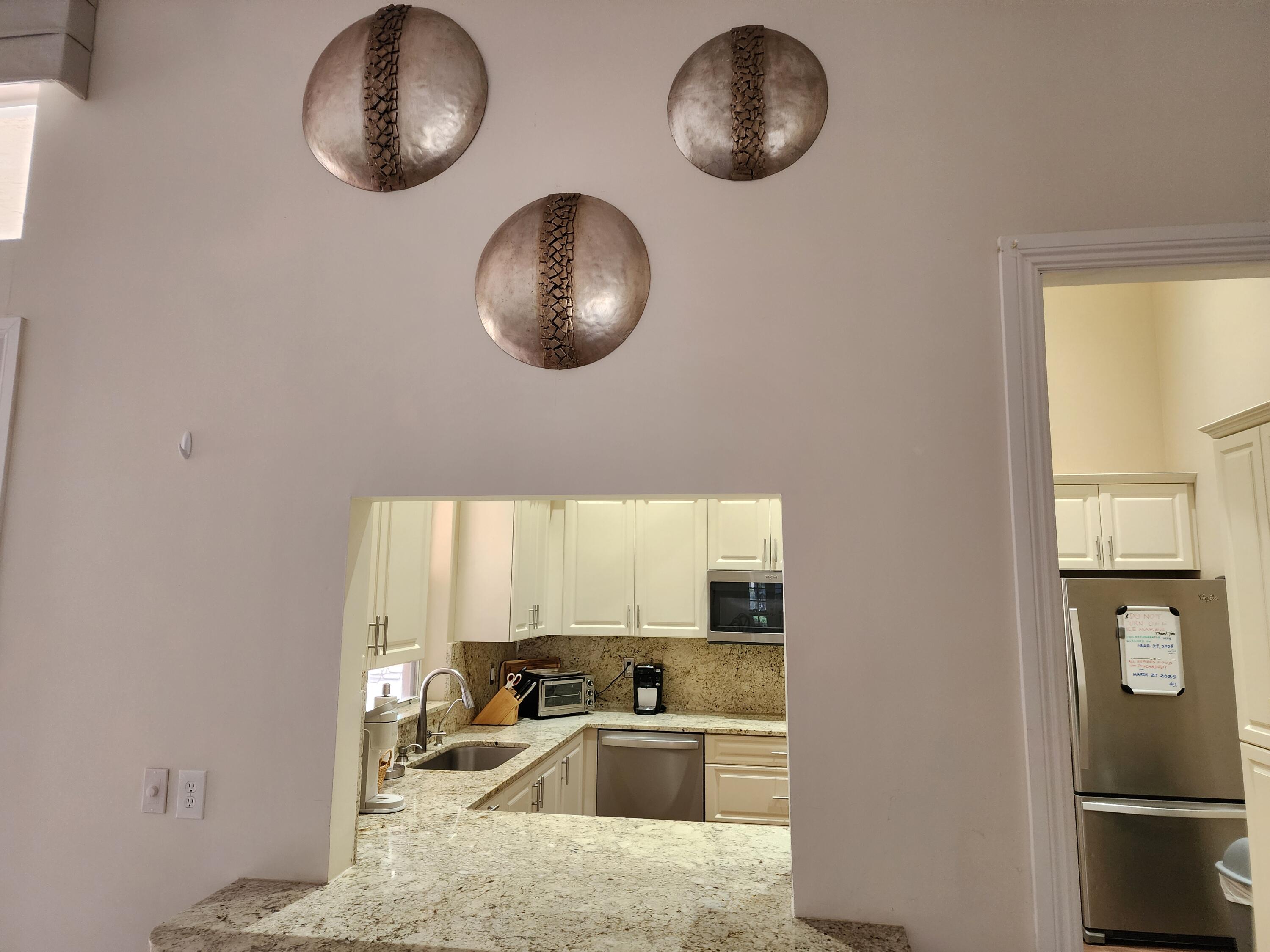 7316 Modena Drive Boynton Beach, FL 33437 - Photo 17 of 24 a kitchen with a refrigerator and a sink