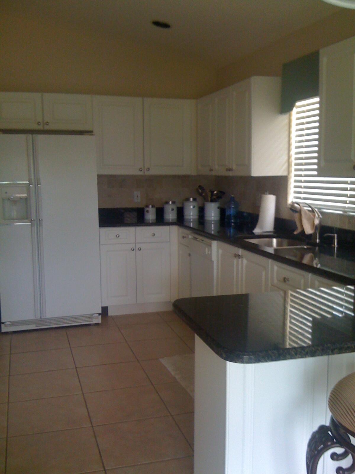 7316 Modena Drive Boynton Beach, FL 33437 - Photo 5 of 24 a kitchen with granite countertop a sink a stove and cabinets