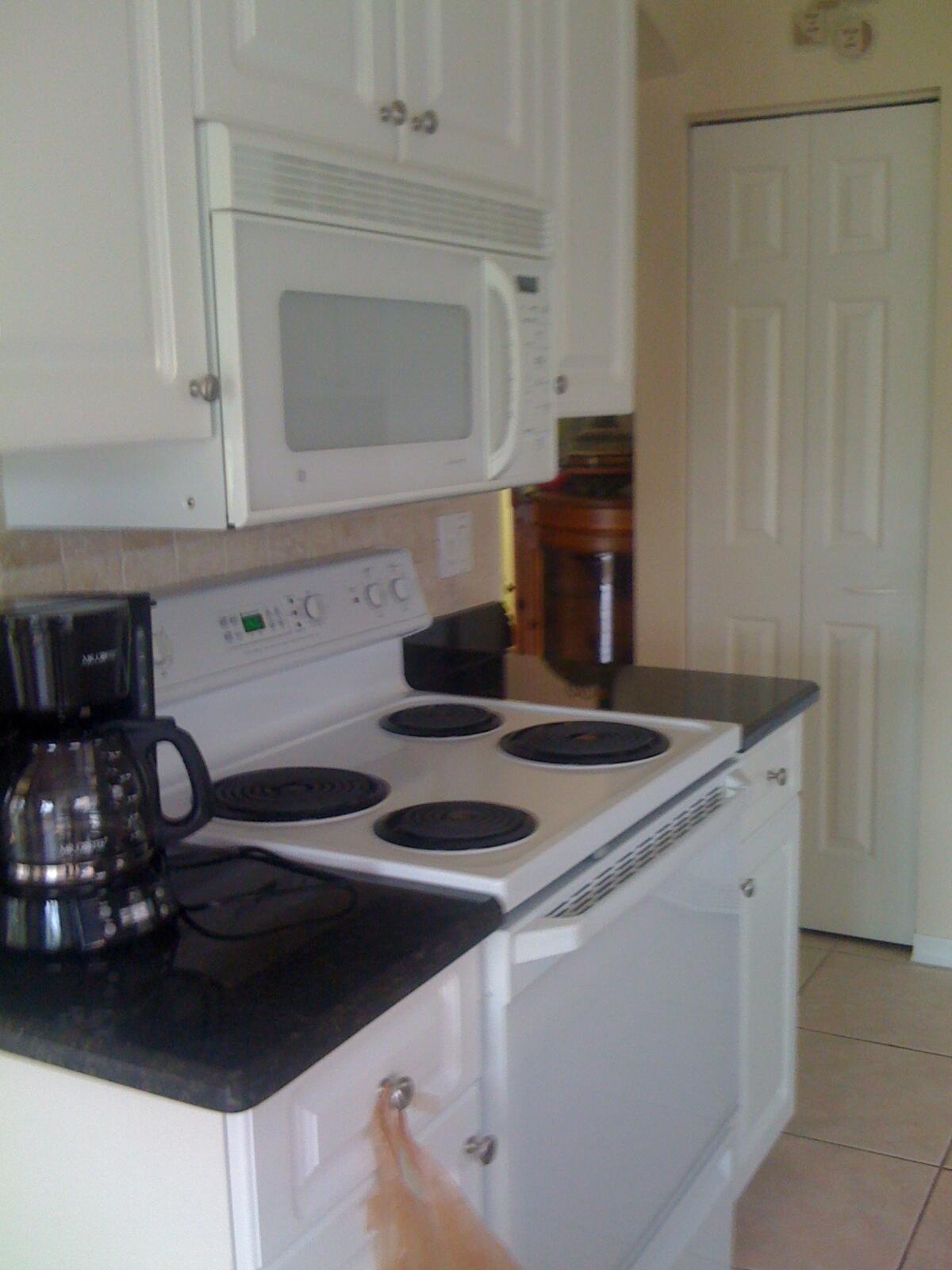 7316 Modena Drive Boynton Beach, FL 33437 - Photo 6 of 24 a kitchen with a stove and a microwave