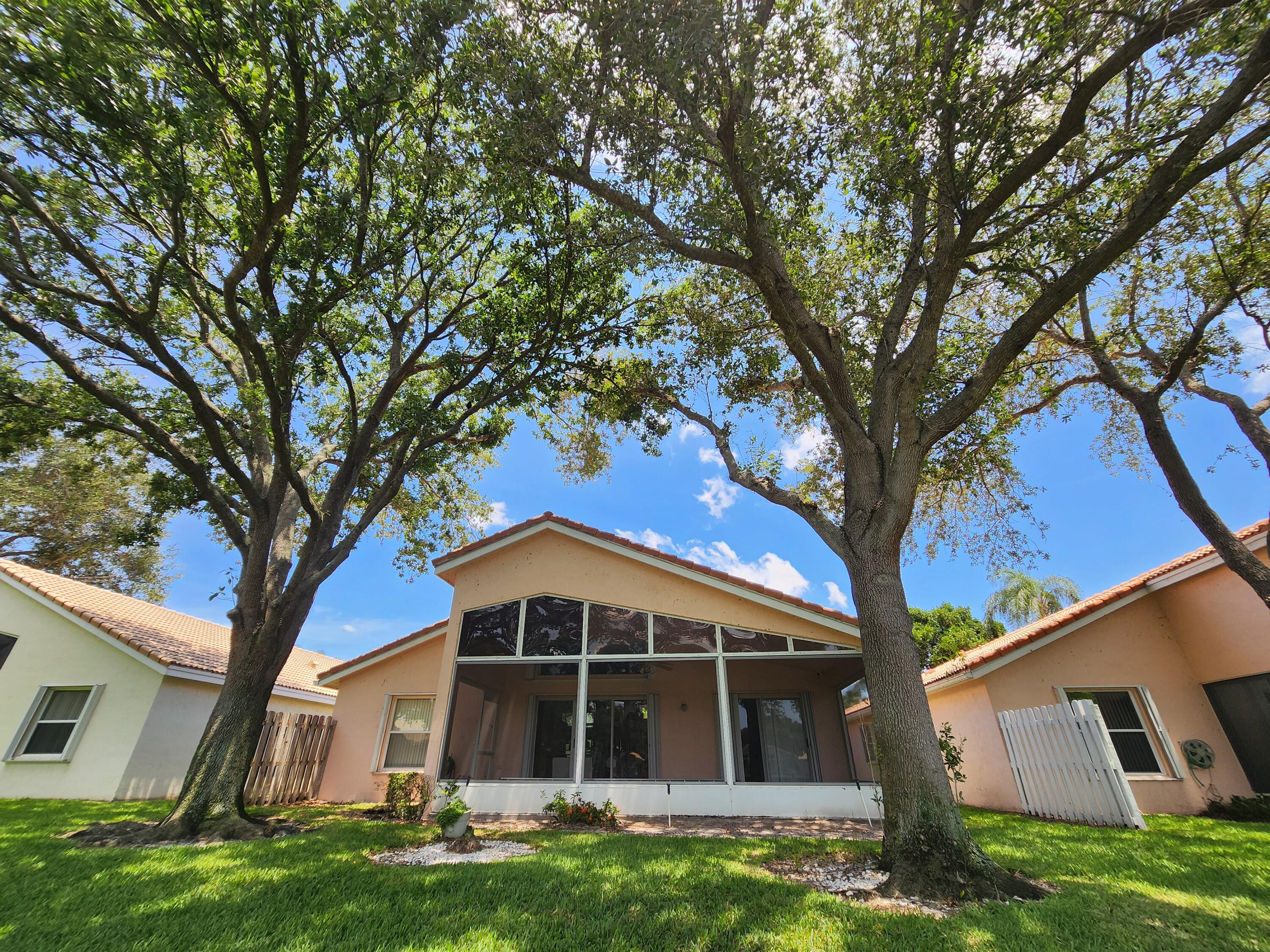 7316 Modena Drive Boynton Beach, FL 33437 - Photo 8 of 24 a front view of a house with a yard