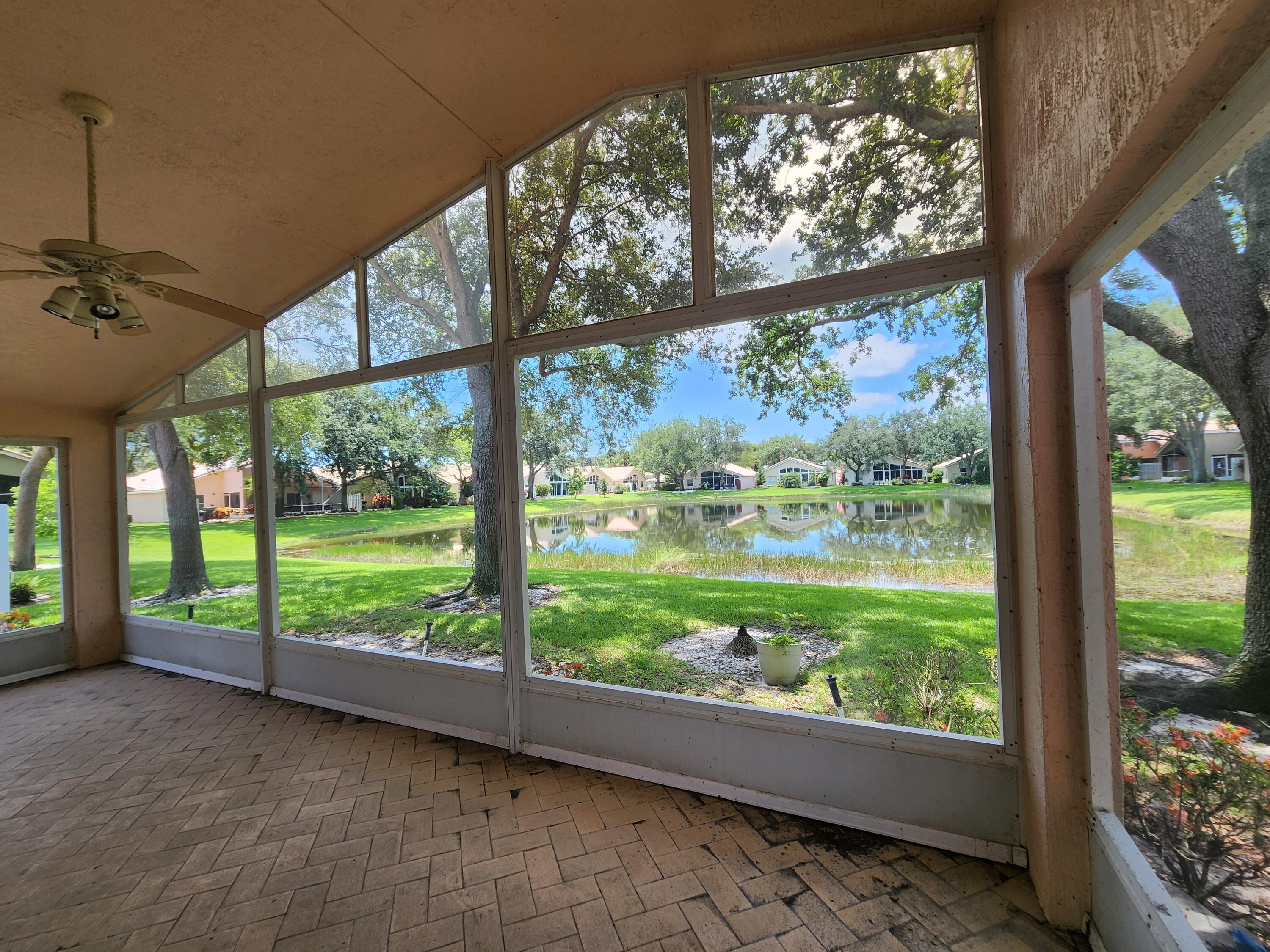 7316 Modena Drive Boynton Beach, FL 33437 - Photo 9 of 24 a view of a room with large windows and plants