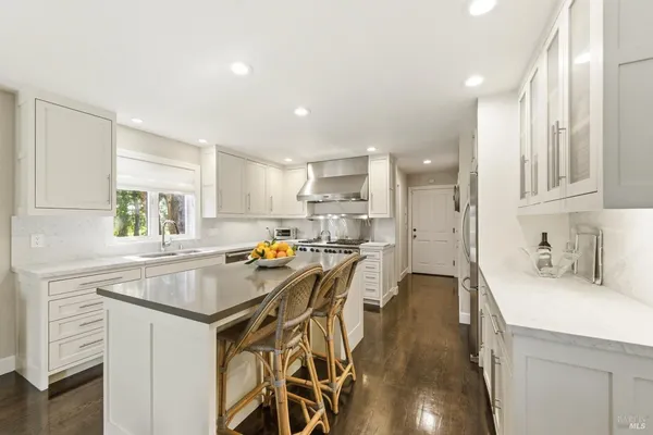 a kitchen with a sink a stove a refrigerator and cabinets