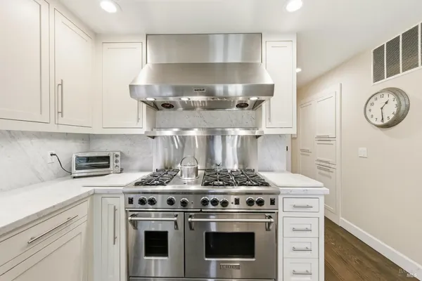 a stove top oven sitting inside of a kitchen